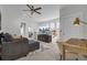 Bright living room features neutral paint, modern ceiling fan, media center, and stylish furnishings at 1821 Mead Ln, Johns Island, SC 29455