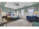 A spacious main bedroom features a tray ceiling, ceiling fan, and sitting area with lots of natural light at 1821 Mead Ln, Johns Island, SC 29455