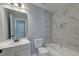 Bathroom with marble tile, updated vanity, and shower-tub combination at 2076 Wild Flower Ln, Charleston, SC 29414