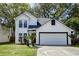 Charming two-story home features a well-maintained lawn, garage and a classic white exterior at 2076 Wild Flower Ln, Charleston, SC 29414