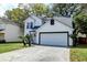 Charming two-story home with a driveway and palm trees in the front yard at 2076 Wild Flower Ln, Charleston, SC 29414