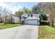 Charming two-story home boasts a well-manicured lawn, a garage, and a classic white exterior at 2076 Wild Flower Ln, Charleston, SC 29414