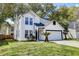 Charming two-story home features a well-maintained lawn, garage and a classic white exterior at 2076 Wild Flower Ln, Charleston, SC 29414