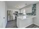 Modern kitchen with stainless steel appliances, white cabinets, and stylish blue backsplash at 2076 Wild Flower Ln, Charleston, SC 29414