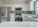 Newly renovated kitchen featuring stainless steel appliances and stylish backsplash at 2076 Wild Flower Ln, Charleston, SC 29414