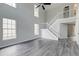 Bright living room boasting soaring ceilings, large windows, and elegant gray wood floors at 2076 Wild Flower Ln, Charleston, SC 29414