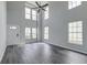 Spacious living room featuring high ceilings, abundant natural light, and modern gray wood flooring at 2076 Wild Flower Ln, Charleston, SC 29414