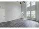 Spacious living room with a high ceiling and lots of natural light from the large windows at 2076 Wild Flower Ln, Charleston, SC 29414