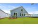 Well maintained backyard featuring bright green grass and blue vinyl siding at 2239 Macallan Blvd, Ravenel, SC 29470