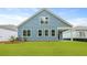 Charming blue home with a well-manicured green lawn and a covered porch, perfect for outdoor enjoyment at 2239 Macallan Blvd, Ravenel, SC 29470