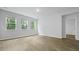 A bright, naturally lit bedroom with three windows and light vinyl flooring at 2239 Macallan Blvd, Ravenel, SC 29470