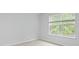Bright bedroom with large window offering pleasant outdoor views, complemented by neutral walls and cozy carpeting at 2239 Macallan Blvd, Ravenel, SC 29470