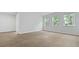A bright bedroom with light vinyl flooring and three large windows at 2239 Macallan Blvd, Ravenel, SC 29470