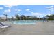 Community pool featuring many lounge chairs and umbrellas and plenty of trees at 2239 Macallan Blvd, Ravenel, SC 29470