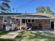 Cozy covered patio area complete with grill, seating, and access to the backyard lawn at 260 Carolina Cir, Walterboro, SC 29488