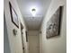 A hallway with a pull down attic entrance and framed paintings at 260 Carolina Cir, Walterboro, SC 29488