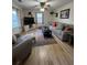 Bright living room with hardwood floors, comfortable seating, and ample natural light from large windows at 260 Carolina Cir, Walterboro, SC 29488
