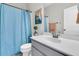 Well-lit bathroom with a single vanity, modern fixtures, and shower with blue shower curtain at 271 Palmetto Walk Dr, Summerville, SC 29486