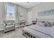 Bright bedroom with light-grey walls, white trim, chair, and comfortable furnishings and natural light at 271 Palmetto Walk Dr, Summerville, SC 29486
