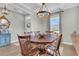 Inviting dining area features a wooden table, stylish chandelier, and neutral decor at 271 Palmetto Walk Dr, Summerville, SC 29486