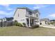View of home's side and front yard with landscaping, rocking chairs on porch, and vinyl siding at 271 Palmetto Walk Dr, Summerville, SC 29486