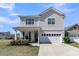 Charming two-story home with a well-manicured lawn, covered porch, and two car garage at 271 Palmetto Walk Dr, Summerville, SC 29486