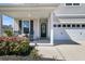 Inviting front porch with black rocking chairs, decorative wreath, and attached two car garage at 271 Palmetto Walk Dr, Summerville, SC 29486