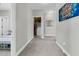 Hallway with neutral paint and carpet leading to a laundry room and bedroom at 271 Palmetto Walk Dr, Summerville, SC 29486