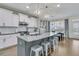 Well-lit kitchen featuring stainless appliances, white cabinets, and a large island with seating at 271 Palmetto Walk Dr, Summerville, SC 29486