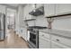 Stylish kitchen featuring a stainless steel gas range, white cabinets, and granite countertops at 271 Palmetto Walk Dr, Summerville, SC 29486