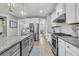 Modern kitchen with stainless steel appliances, granite countertops, and white cabinetry at 271 Palmetto Walk Dr, Summerville, SC 29486