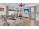 Bright living room with neutral tones, modern fan, large windows and staircase at 271 Palmetto Walk Dr, Summerville, SC 29486
