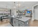 Open concept kitchen and living area with island seating and bright, natural light at 271 Palmetto Walk Dr, Summerville, SC 29486