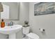 Charming powder room with a pedestal sink, modern fixtures, and sailboat decor at 271 Palmetto Walk Dr, Summerville, SC 29486