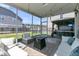 Inviting screened porch with comfortable seating, fire pit, and string lights for relaxing outdoor living at 271 Palmetto Walk Dr, Summerville, SC 29486