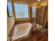 Relaxing bathroom with jacuzzi tub and glass block window at 2729 Barracada Rd, Walterboro, SC 29488