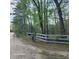 Rustic driveway leading to a charming property with a wooden fence and 'Red Gate' signage at 2729 Barracada Rd, Walterboro, SC 29488