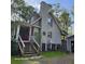 A look at the home's rear, featuring stairs and wood construction in a partially wooded lot at 2729 Barracada Rd, Walterboro, SC 29488