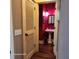 Stylish half bathroom featuring a pedestal sink, red walls, and unique lighting at 2729 Barracada Rd, Walterboro, SC 29488