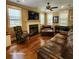 Cozy living room with hardwood floors, a fireplace, and bright windows at 2729 Barracada Rd, Walterboro, SC 29488