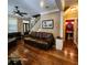 Bright living room featuring hardwood floors, staircase, and doorway to a half bath at 2729 Barracada Rd, Walterboro, SC 29488