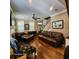Spacious living room featuring hardwood floors, a fireplace, and staircase access at 2729 Barracada Rd, Walterboro, SC 29488