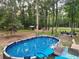 Backyard features an above ground pool with surrounding trees at 2729 Barracada Rd, Walterboro, SC 29488