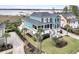Aerial view of a beautiful teal home with well-manicured lawn, lush landscaping and a private driveway at 2777 Oak Manor Dr, Mount Pleasant, SC 29466