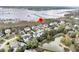 Aerial view of a waterfront home with a pool and a pier, surrounded by lush greenery and a serene lake at 2777 Oak Manor Dr, Mount Pleasant, SC 29466