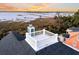 Scenic aerial view featuring a rooftop deck, waterfront, marsh views and sunset in the background at 2777 Oak Manor Dr, Mount Pleasant, SC 29466