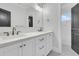Elegant bathroom featuring dual sinks, white cabinetry, and a glass-enclosed shower at 2777 Oak Manor Dr, Mount Pleasant, SC 29466