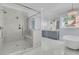 Bright bathroom with a marble walk-in shower, free-standing tub, and gray double sink vanity with marble floors at 2777 Oak Manor Dr, Mount Pleasant, SC 29466