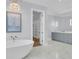 Bathroom features freestanding tub, dual vanities, marble floors and modern lighting at 2777 Oak Manor Dr, Mount Pleasant, SC 29466