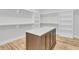 Walk-in closet featuring custom shelving and a marble top island for storage and accessories at 2777 Oak Manor Dr, Mount Pleasant, SC 29466